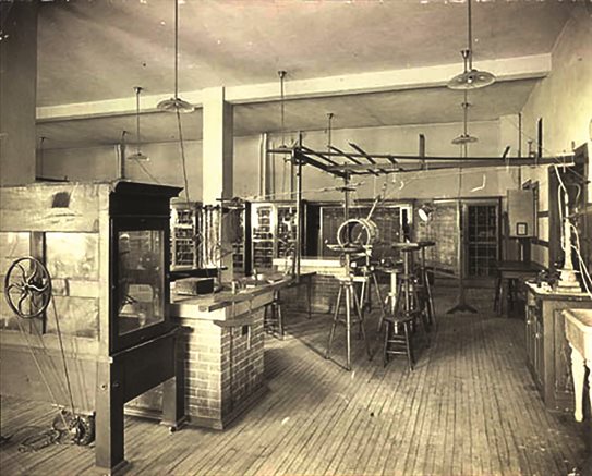 A 1917 photo of the Electricity & Magnetism (E&M) Laboratory at the University of Illinois at Urbana-Champaign. Illinois was among the first universities in the country to teach laboratory classes in physics, starting in 1875. Stevens Institute of Technology introduced physics laboratory classes in 1871, and Massachusetts Institute of Technology, in 1873