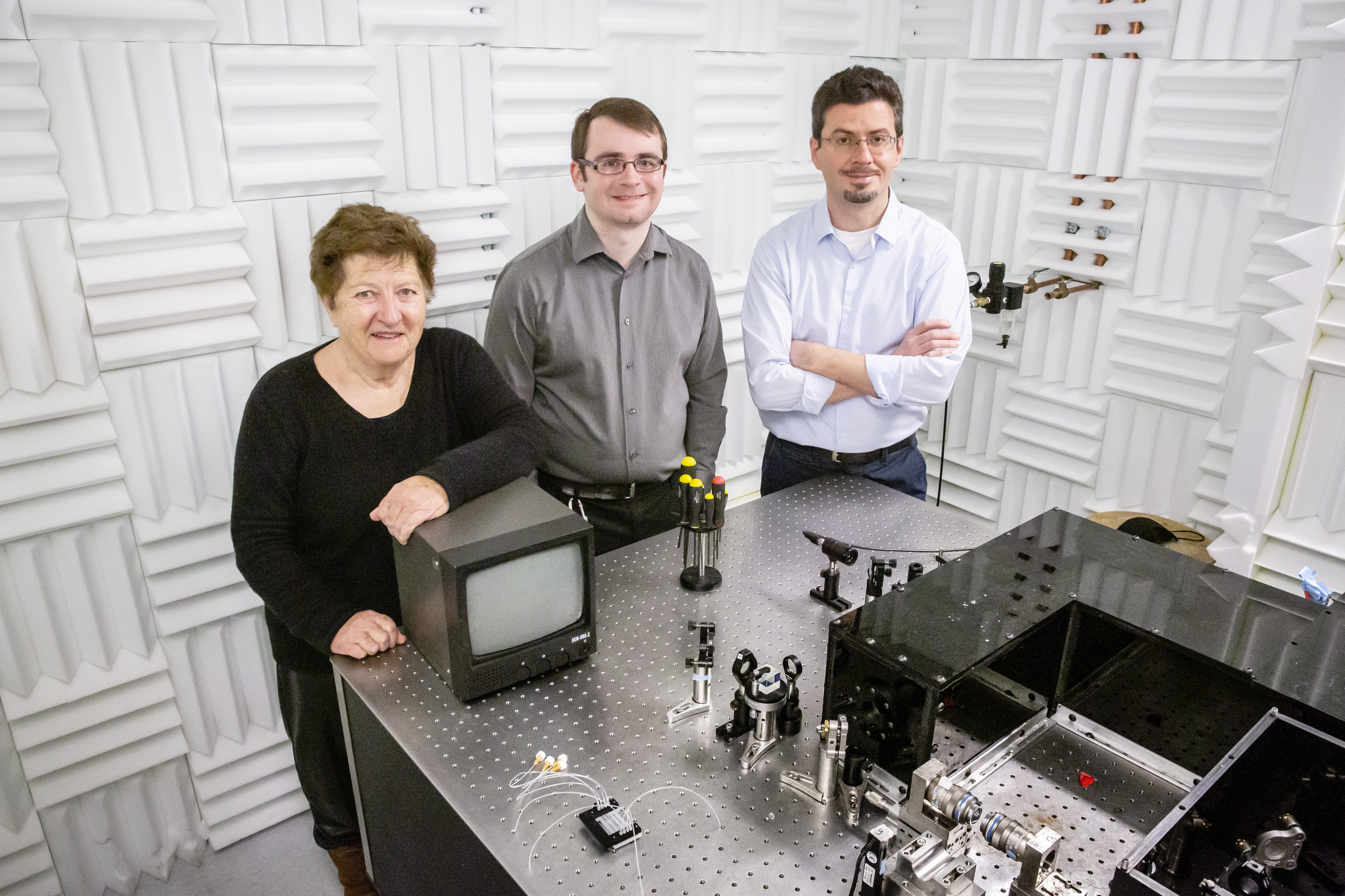 Pictured left to right, Illinois Chemistry and Physics Professor Zan Luthey-Schulten, Illinois Physics graduate student Sean Carney, and Illinois Physics Professor Yann Chemla pose in the Chemla lab at Loomis Laboratory of Physics in Urbana. Photo by L. Brian Stauffer, University of Illinois Urbana-Champaign.