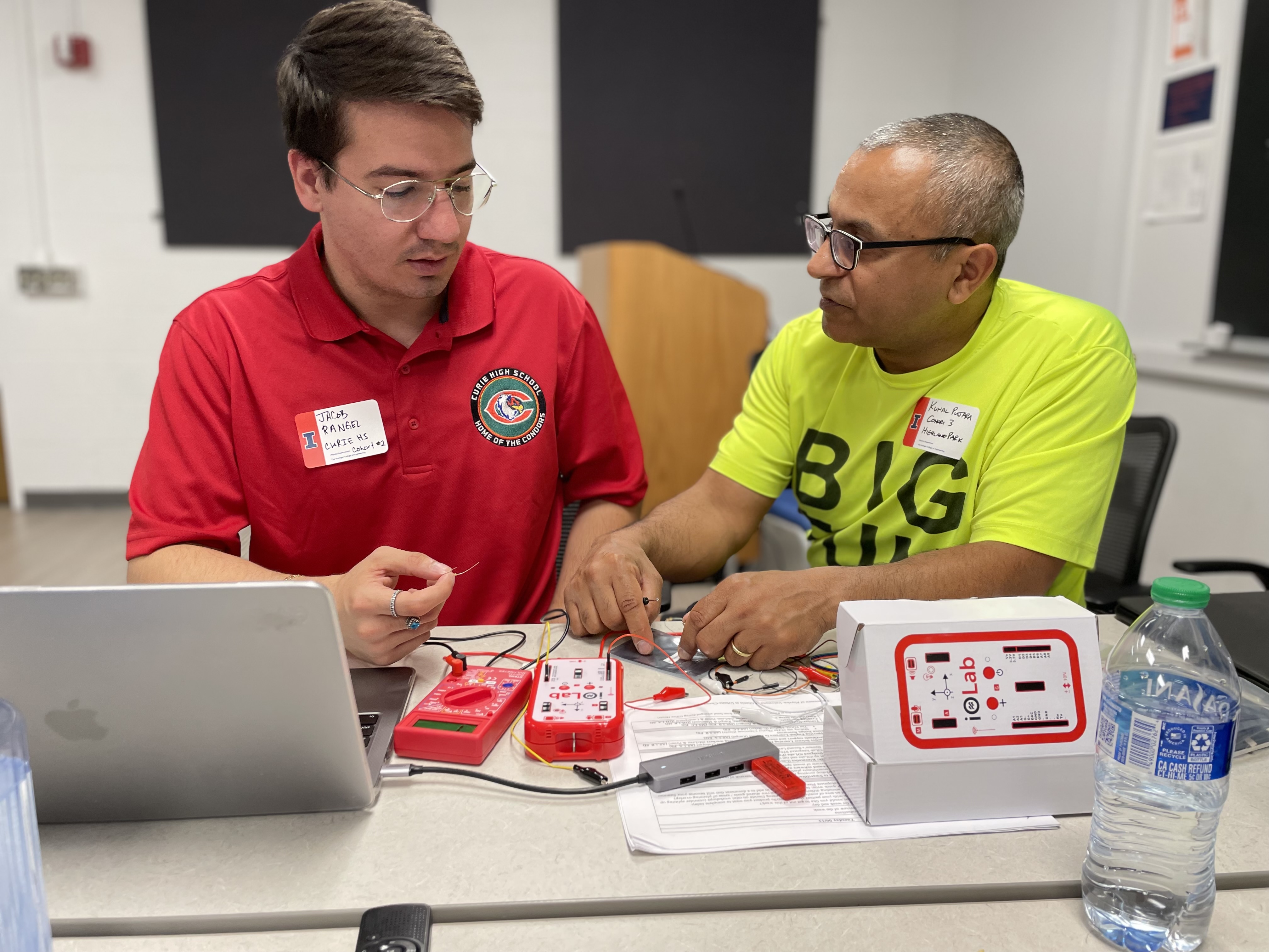 IPaSS teaching fellows Jacob Rangel (left) and Kunal Pujara collaborate to develop an iOLab activity for the electricity &amp; magnetism curriculum. Rangel is an alumnus of Illinois Physics. Photo courtesy of Maggie Mahmood, Illinois Physics&nbsp;&nbsp;