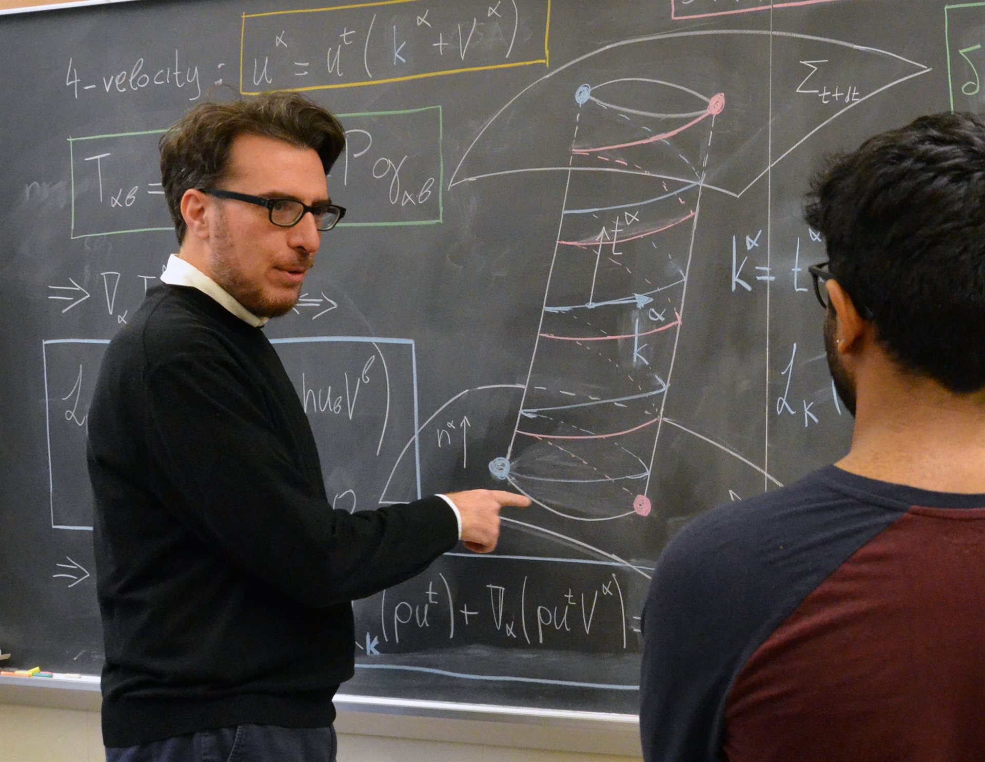 Research Professor Antonios Tsokaros (left) meets with an undergraduate student at Loomis Laboratory of Physics. Photo by Siv Schwink for Illinois Physics